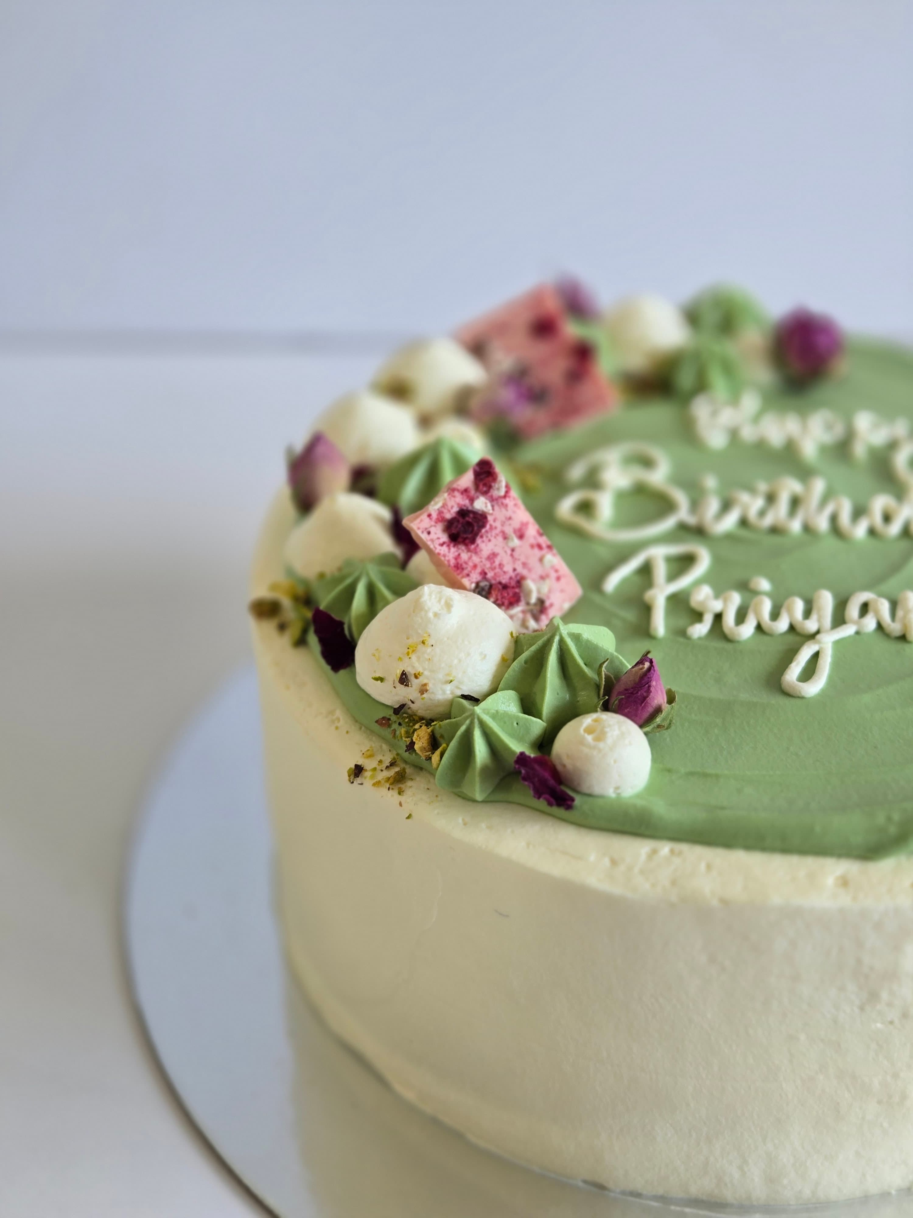 Custom birthday cake with sage frosting, meringues, and dried flowers